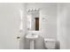 All-white bathroom with a pedestal sink and modern lighting at 1033 Sabine Pl, Kissimmee, FL 34759