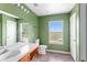 Bathroom with green walls, tile floors, and white vanity with sink at 1033 Sabine Pl, Kissimmee, FL 34759