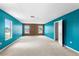 Spacious bedroom with neutral carpet, multiple windows, and two-tone paint at 1033 Sabine Pl, Kissimmee, FL 34759