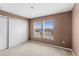 Neutral bedroom with closet, carpet, and windows providing plenty of natural light at 1033 Sabine Pl, Kissimmee, FL 34759