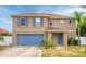 Two-story home with blue shutters and a matching blue garage door and front door at 1033 Sabine Pl, Kissimmee, FL 34759