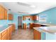 Bright kitchen featuring tile floor, wooden cabinets, and laminate countertops at 1033 Sabine Pl, Kissimmee, FL 34759