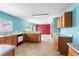 Bright kitchen with tile floor and wooden cabinets, view into a living area at 1033 Sabine Pl, Kissimmee, FL 34759