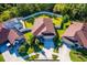 Aerial view of a home with solar panels, a pool, and well-maintained landscaping at 113 San Mardeen Ct, Daytona Beach, FL 32117