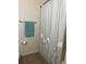 Standard bathroom featuring a shower with a seashell-themed curtain and a towel bar at 113 San Mardeen Ct, Daytona Beach, FL 32117