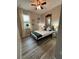 This bedroom features a ceiling fan, a double bed, wood floors, and a window with curtains at 113 San Mardeen Ct, Daytona Beach, FL 32117