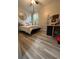 This bedroom features a ceiling fan, mirror, double bed, and wood floors at 113 San Mardeen Ct, Daytona Beach, FL 32117