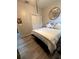 This bedroom features a mirror, double bed, wood floors, and closet with folding doors at 113 San Mardeen Ct, Daytona Beach, FL 32117