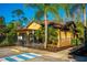 Community clubhouse with accessible parking featuring covered seating area and lush landscaping at 113 San Mardeen Ct, Daytona Beach, FL 32117
