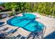 Community pool featuring crystal-clear water, comfortable lounge chairs, and brick-paved deck at 113 San Mardeen Ct, Daytona Beach, FL 32117