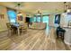 Open-concept living area featuring wood floors, modern lighting fixtures, and a dining space at 113 San Mardeen Ct, Daytona Beach, FL 32117