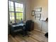 This office space features a large window, a ceiling fan, wood floors, and a large desk at 113 San Mardeen Ct, Daytona Beach, FL 32117