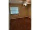 A standard bedroom with a ceiling fan, window with blinds, and neutral colored carpet at 120 Hibiscus Woods Ct # 11B, Deltona, FL 32725