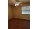 A standard bedroom with a ceiling fan, window with blinds, and neutral colored carpet at 120 Hibiscus Woods Ct # 11B, Deltona, FL 32725