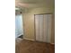 This cozy bedroom features neutral walls and a closet with folding doors at 120 Hibiscus Woods Ct # 11B, Deltona, FL 32725