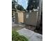 A beige dumpster area with concrete enclosure and landscaping at 120 Hibiscus Woods Ct # 11B, Deltona, FL 32725