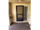 A unit entryway featuring a storm door, a small window, and unit number marker at 120 Hibiscus Woods Ct # 11B, Deltona, FL 32725