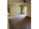 Spacious living room featuring neutral carpet, adjacent dining nook and sliding glass doors at 120 Hibiscus Woods Ct # 11B, Deltona, FL 32725