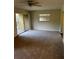 Open-concept living room featuring neutral paint, carpet and a large window at 120 Hibiscus Woods Ct # 11B, Deltona, FL 32725