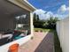 Back patio of the home featuring red brick pavers and an enclosed lanai at 12728 Boggy Pointe Dr, Orlando, FL 32824