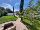 Backyard area featuring brick pavers, a fire pit, and green grass at 12728 Boggy Pointe Dr, Orlando, FL 32824