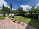 Spacious backyard featuring well manicured landscaping and red brick pavers at 12728 Boggy Pointe Dr, Orlando, FL 32824