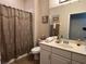 Bathroom featuring a vanity with a sink and the shower featuring a decorative shower curtain at 12728 Boggy Pointe Dr, Orlando, FL 32824