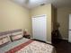Bedroom featuring neutral decor, patterned bedding, a closet, and a side table with lamp at 12728 Boggy Pointe Dr, Orlando, FL 32824
