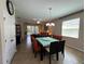 Spacious dining room with modern table, seating for eight, and tile flooring at 12728 Boggy Pointe Dr, Orlando, FL 32824