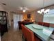 Open-concept dining area flows into the living room, featuring a modern table and chandelier lighting at 12728 Boggy Pointe Dr, Orlando, FL 32824
