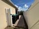 Exterior view of the home featuring waste receptacles and a white fence at 12728 Boggy Pointe Dr, Orlando, FL 32824