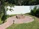 Exterior shot of a brick fire pit with surrounding brick pavers and green grass at 12728 Boggy Pointe Dr, Orlando, FL 32824