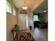 Inviting foyer with decorative rug, console table, and transom window above the front door at 12728 Boggy Pointe Dr, Orlando, FL 32824
