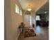 Inviting foyer with decorative rug, console table, and transom window above the front door at 12728 Boggy Pointe Dr, Orlando, FL 32824
