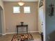 Bright entryway showcasing tile flooring, a decorative rug, and a view of the front door at 12728 Boggy Pointe Dr, Orlando, FL 32824
