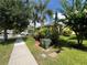 View of well manicured front yard featuring lush landscaping, and trees at 12728 Boggy Pointe Dr, Orlando, FL 32824