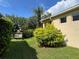 Exterior front yard features lush green grass, mulch, and flowering trees at 12728 Boggy Pointe Dr, Orlando, FL 32824