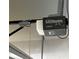 Garage door opener motor with safety pull cord and electrical wiring at 12728 Boggy Pointe Dr, Orlando, FL 32824