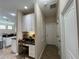 Hallway features built-in desk with overhead cabinets, tile floors, and doors to other rooms at 12728 Boggy Pointe Dr, Orlando, FL 32824