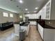 Bright kitchen with white cabinetry, granite countertops, stainless steel appliances, and a central island at 12728 Boggy Pointe Dr, Orlando, FL 32824