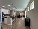 Open-concept kitchen featuring a large island with bar seating and seamless flow to the dining area at 12728 Boggy Pointe Dr, Orlando, FL 32824