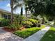 Landscaped sidewalk with beautiful landscaping, plants, and trees at 12728 Boggy Pointe Dr, Orlando, FL 32824