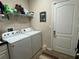 Bright laundry room featuring appliances and ample storage space, next to the door at 12728 Boggy Pointe Dr, Orlando, FL 32824