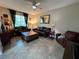 Cozy living room with tile flooring, comfortable leather furniture, and ample natural light at 12728 Boggy Pointe Dr, Orlando, FL 32824