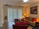Cozy living room with a comfortable sofa, ottoman, and bright natural light at 12728 Boggy Pointe Dr, Orlando, FL 32824