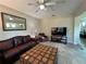 Inviting living room with tile flooring, comfortable seating, and a television for entertainment at 12728 Boggy Pointe Dr, Orlando, FL 32824