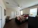 Serene primary bedroom with a comfortable bed, ceiling fan, and natural light from windows at 12728 Boggy Pointe Dr, Orlando, FL 32824