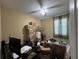 Office space with stacks of boxes, a desk, and a ceiling fan with window and natural light at 12728 Boggy Pointe Dr, Orlando, FL 32824