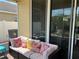 Cozy screened-in patio with comfortable sofa and backyard view at 12728 Boggy Pointe Dr, Orlando, FL 32824
