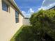 Exterior side yard featuring beautiful green grass and a white fence at 12728 Boggy Pointe Dr, Orlando, FL 32824